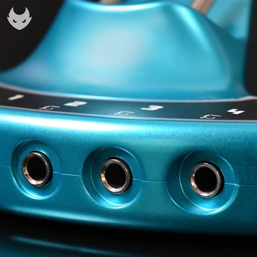 Three quarter-inch output jacks on the front of a teal power supply
