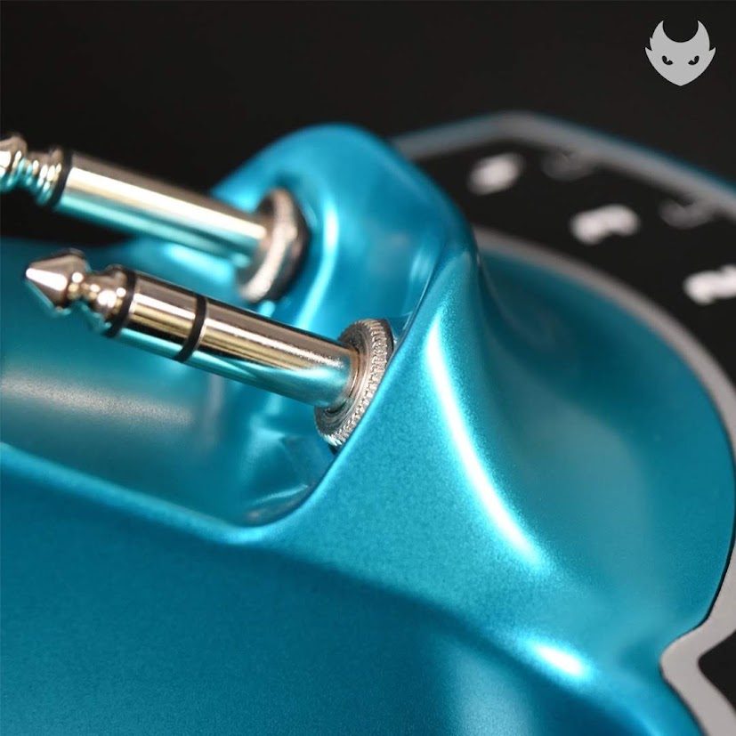 Two phone plugs seated in the jacks with knurled collars