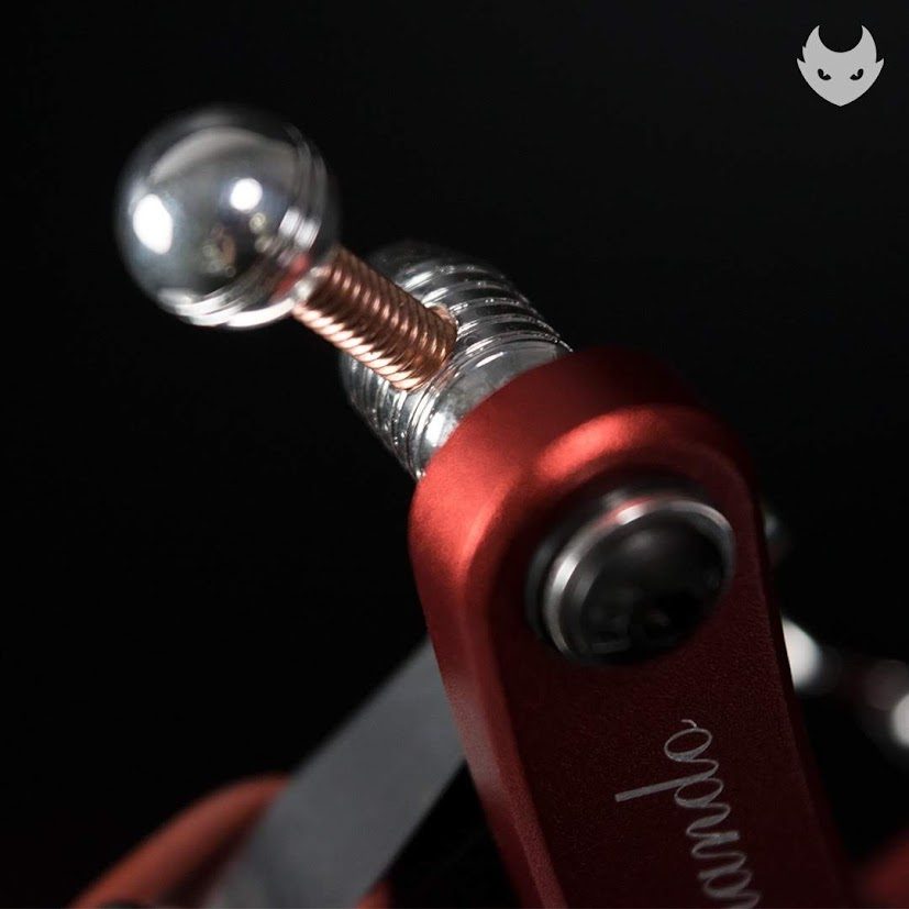 Chrome ball contact and copper spring on a red rotary machine