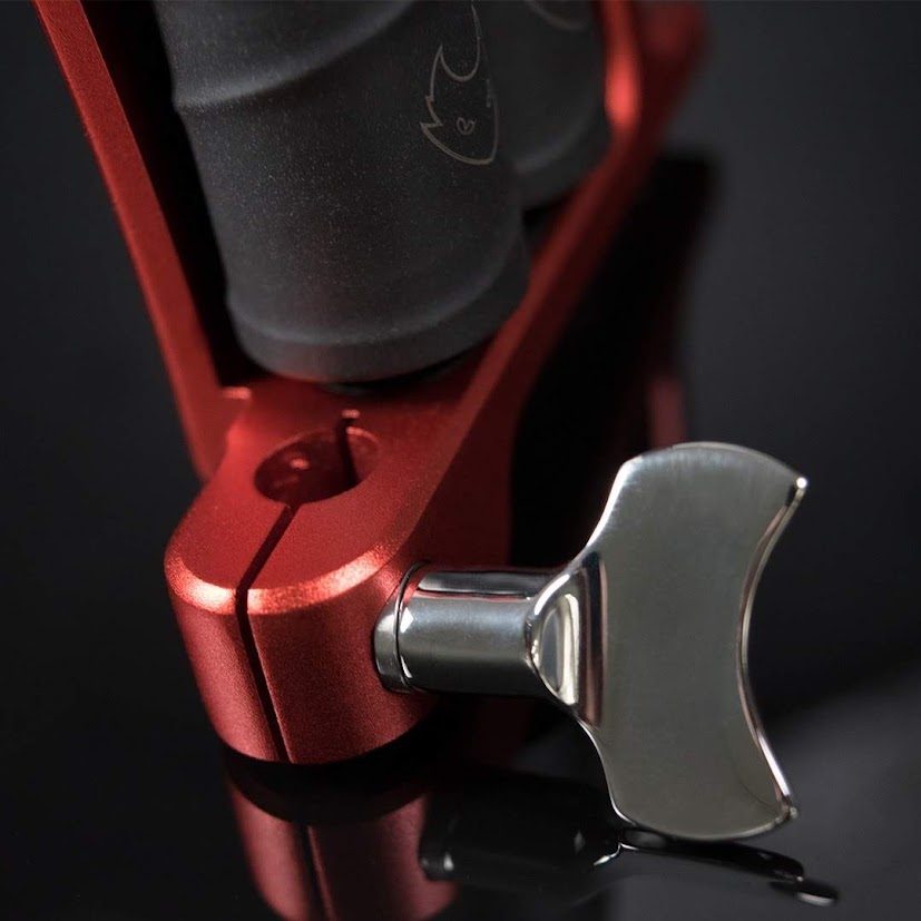 Polished steel wing thumbscrew and grip collar on a red machine