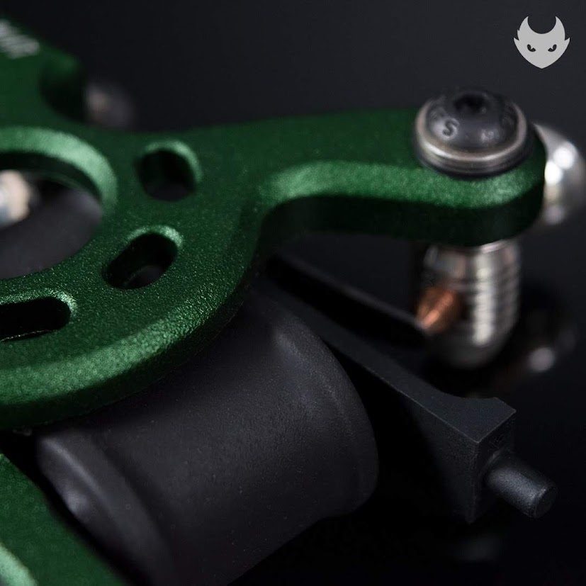 Contact screw with copper tip and batch stamp on a green frame