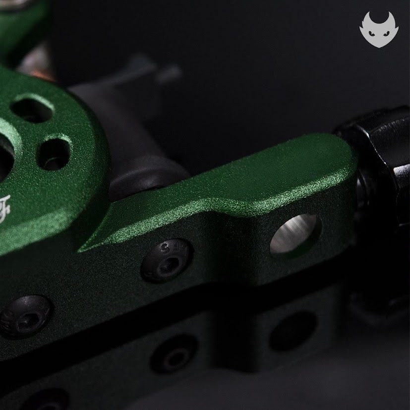 Macro of the green machine frame shoulder, hex screws and batch stamp